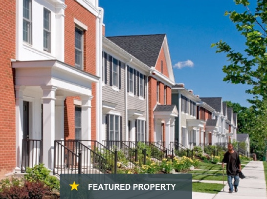 Fairgate garden-style apartments showing inviting, private entrances, with plants and a maintained lawn.