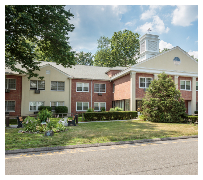 Wormser Congregate has an inviting outdoor area and accessible entrance. The stately exterior has many operable windows.