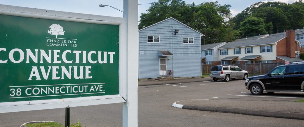 The Connecticut Avenue sign sits left of a view of the housing properties showing plenty of on-street and assigned parking.