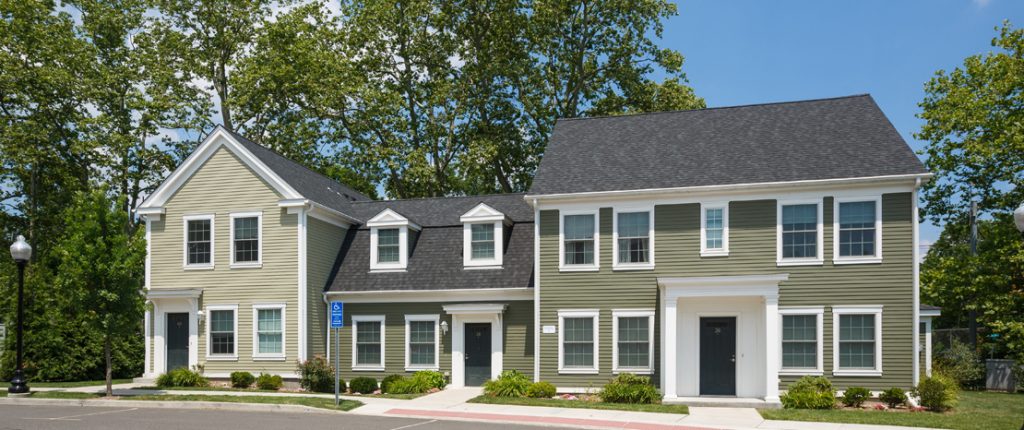 This Colonial-style unit surrounded by trees feature many windows, including a couple dormer windows, and private entrances.