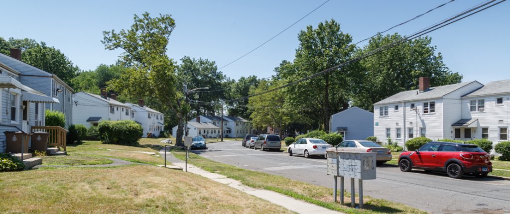 The residential street outside the building allows for parking on both sides. The secure mailboxes are streetside.