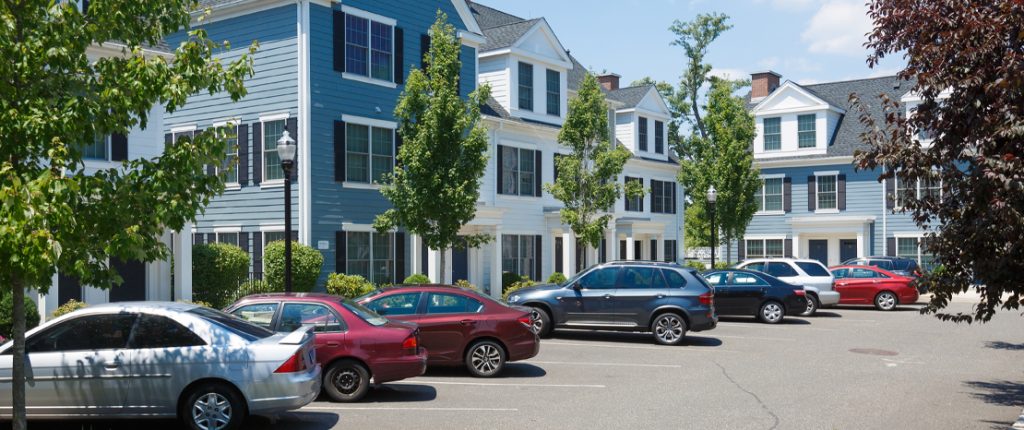 There is plenty of parking in front of these colonial-style units, which also feature many large windows with faux shutters.